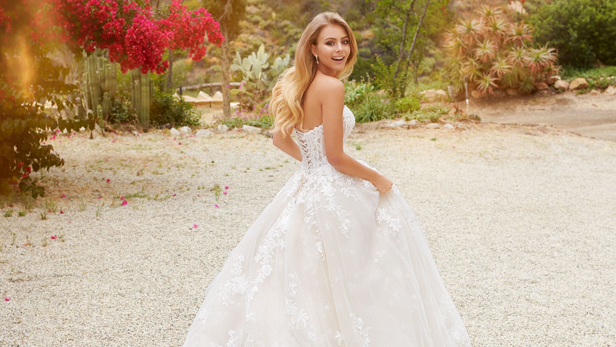 Blonde bride laughing in white ball gown wedding dress
