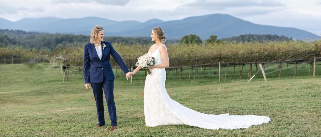 Two brides on their wedding day holding hands