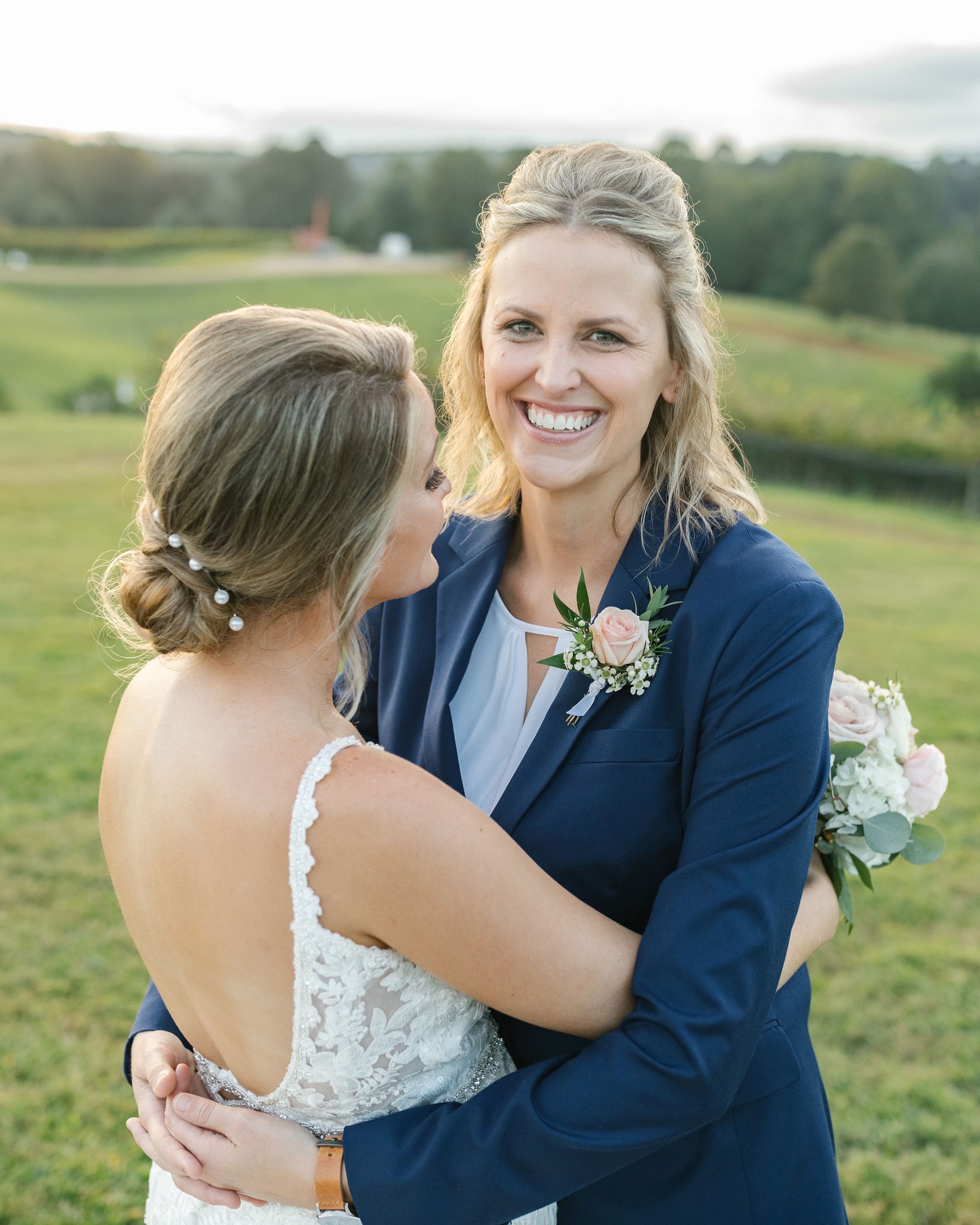 Close up image of two brides holding each other on wedding day