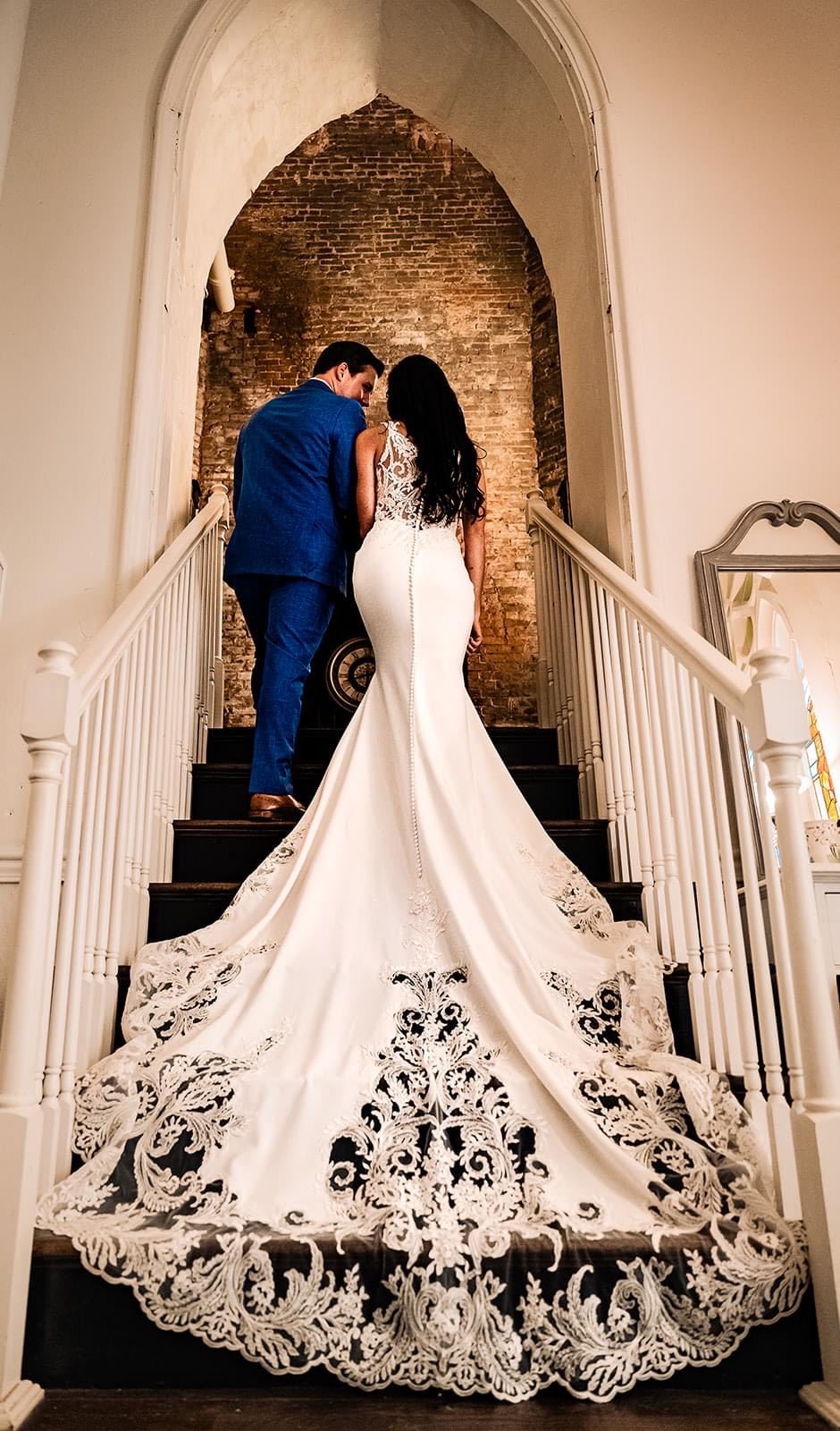 Bride and groom walking upstairs together