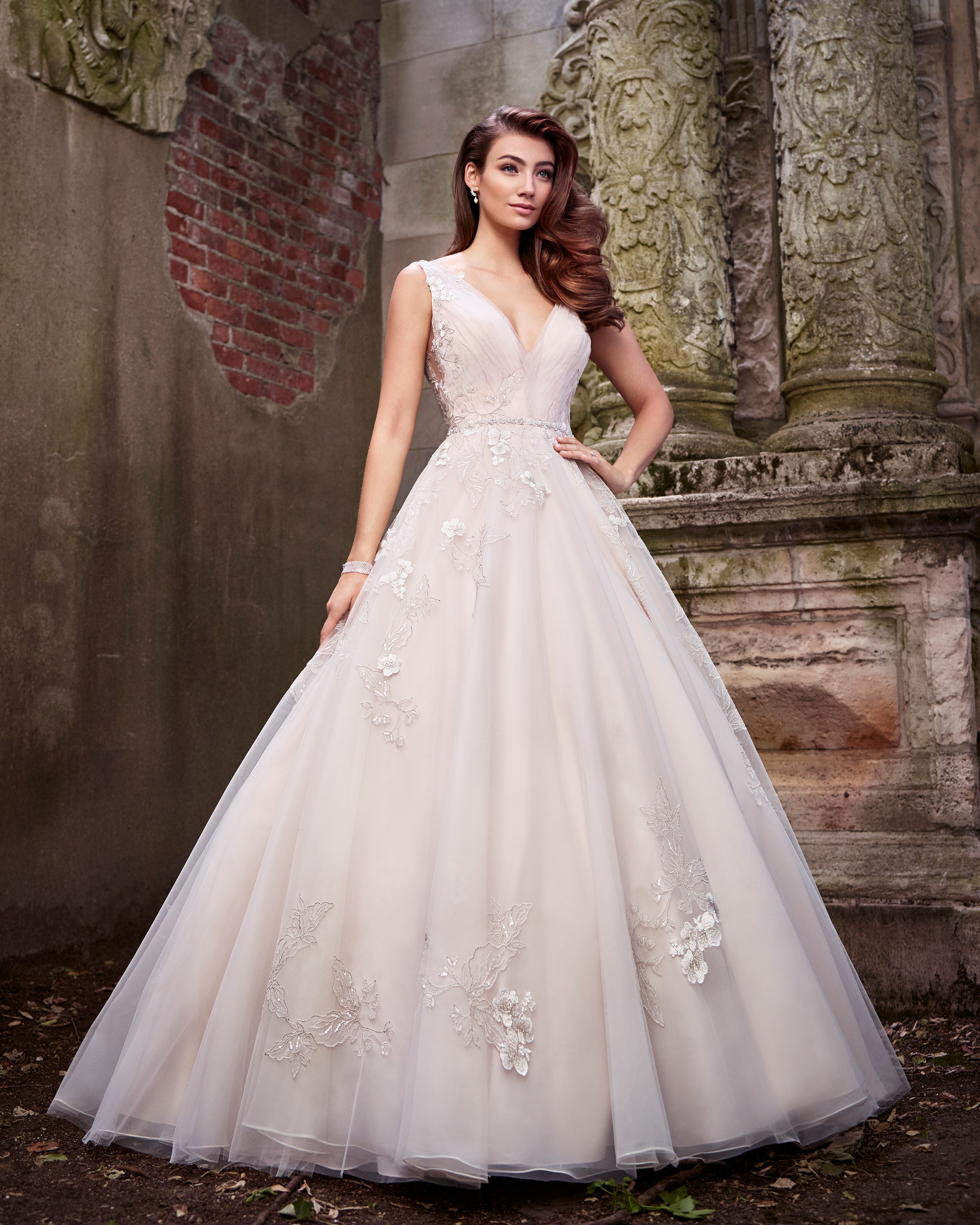 Brunette bride wearing champagne ball gown wedding dress