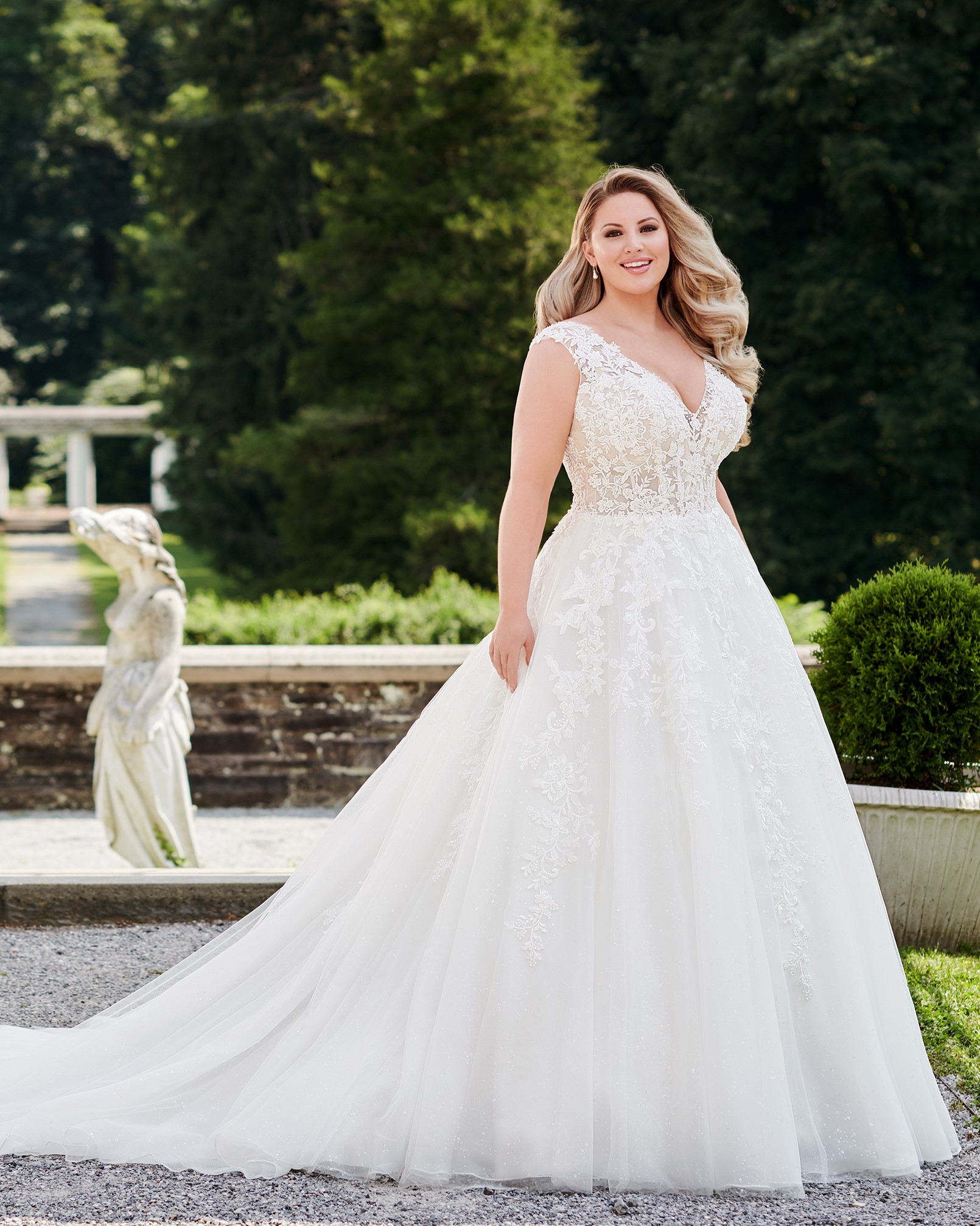 Plus size bride wearing floral lace ball gown wedding dress