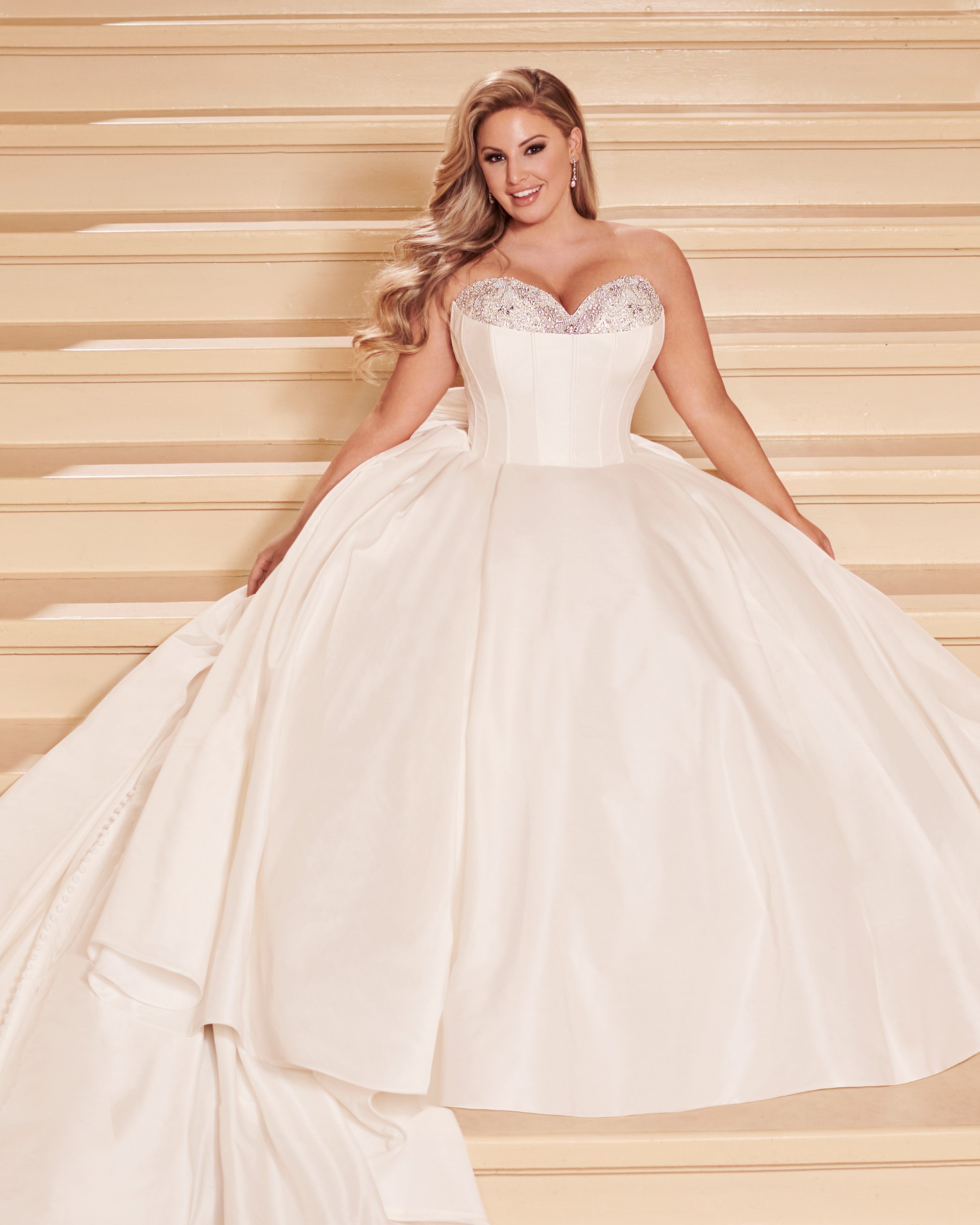 Plus size bride wearing strapless ball gown wedding dress