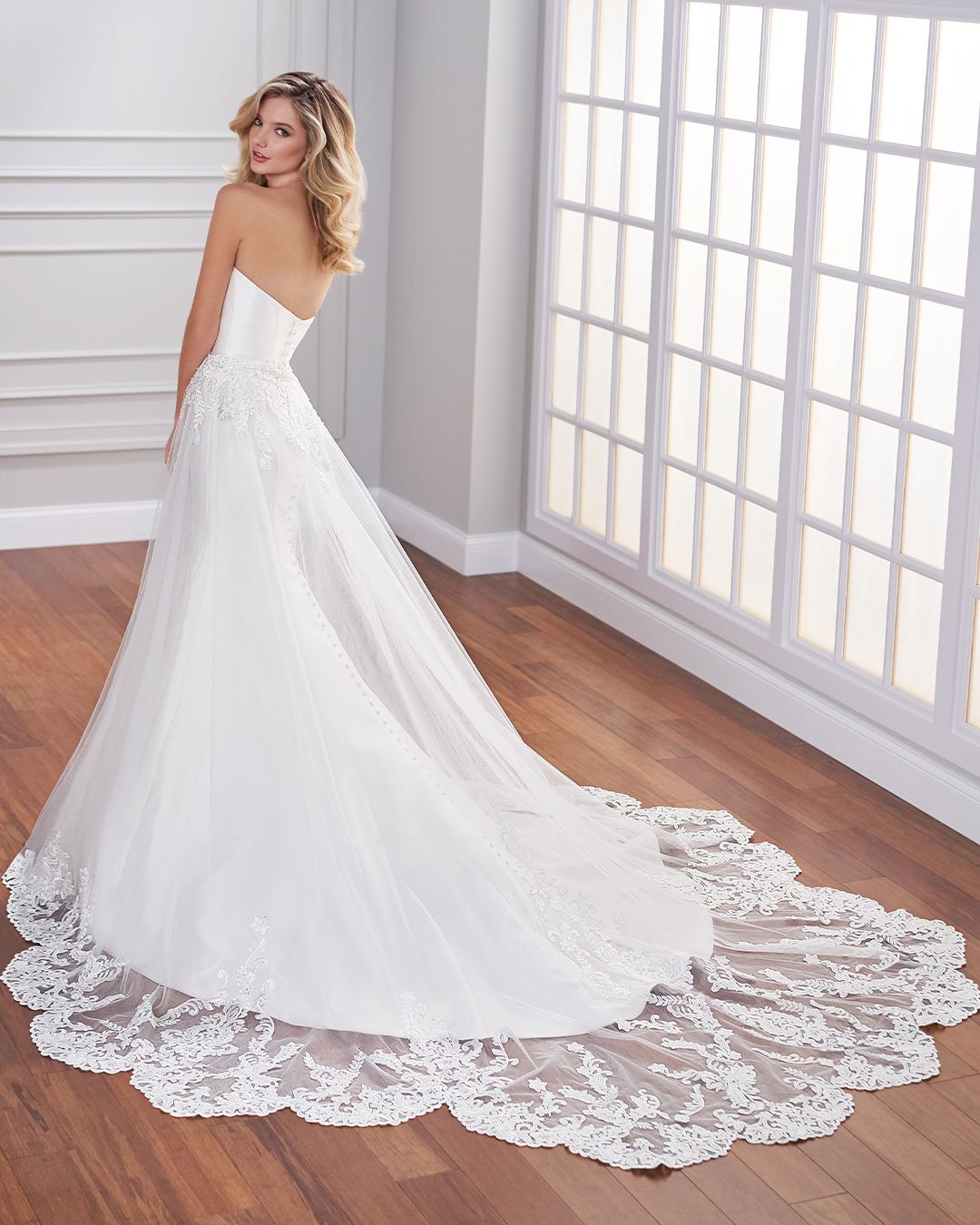 Bride wearing strapless mermaid wedding dress with lace overlay