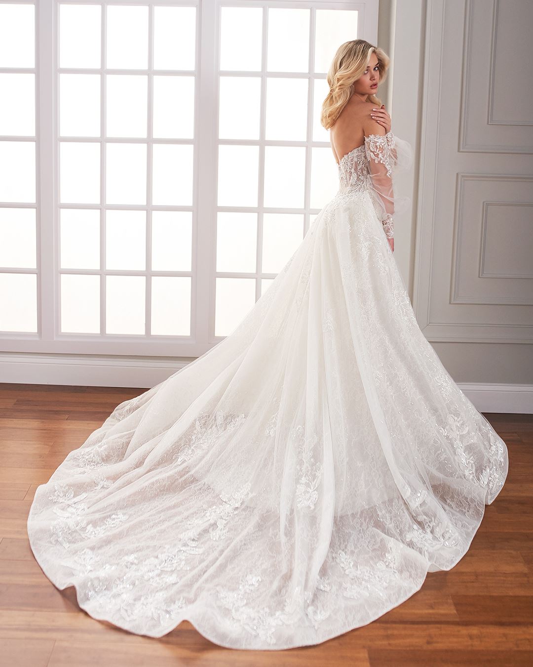 Bride wearing off the shoulder long sleeve lace wedding dress