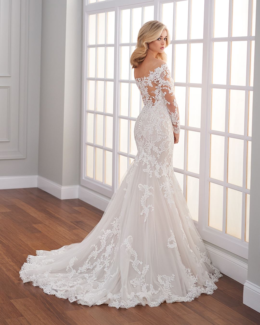 Bride wearing off the shoulder long sleeve wedding dress