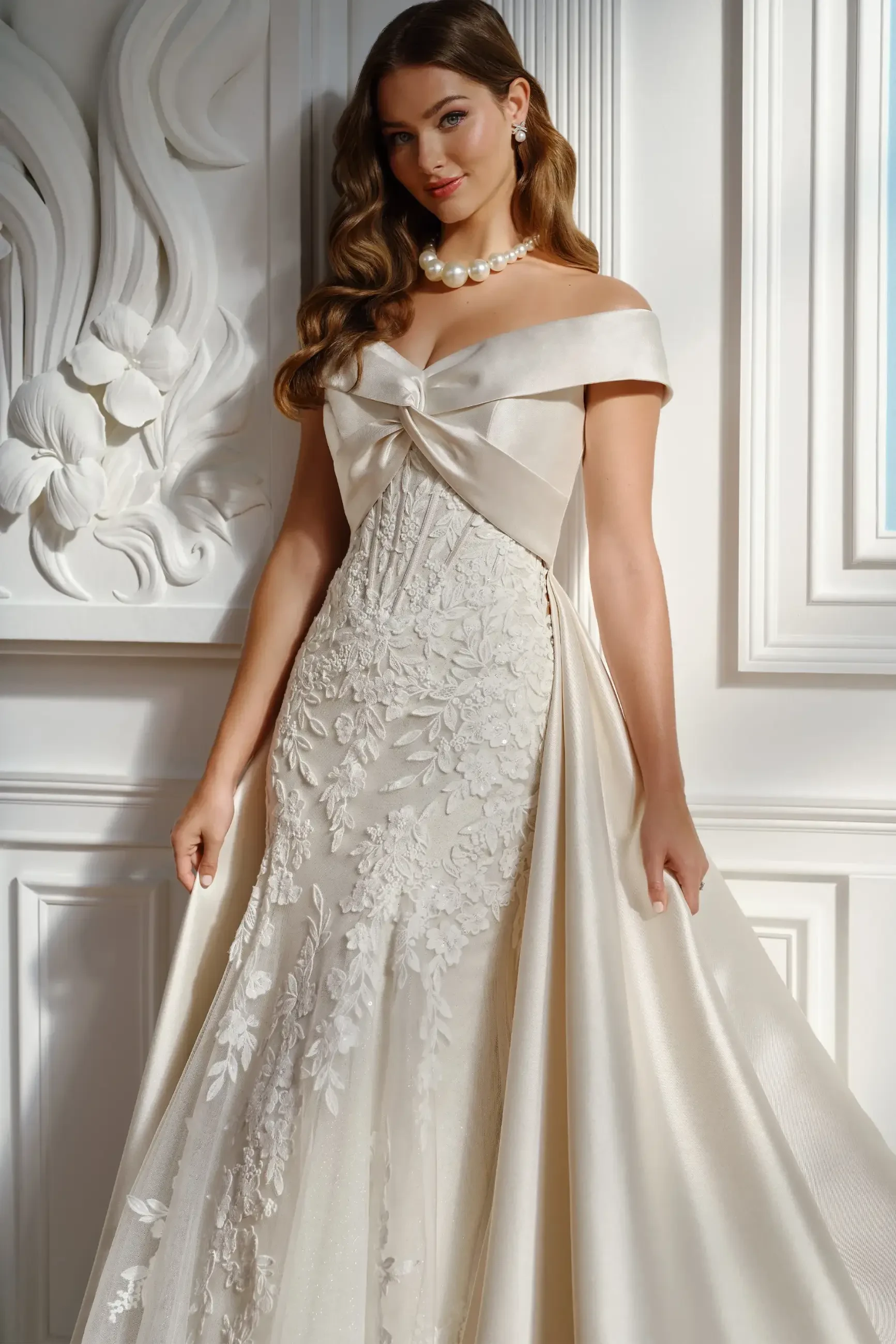model is wearing a strapless lace fit and flare bridal gown 