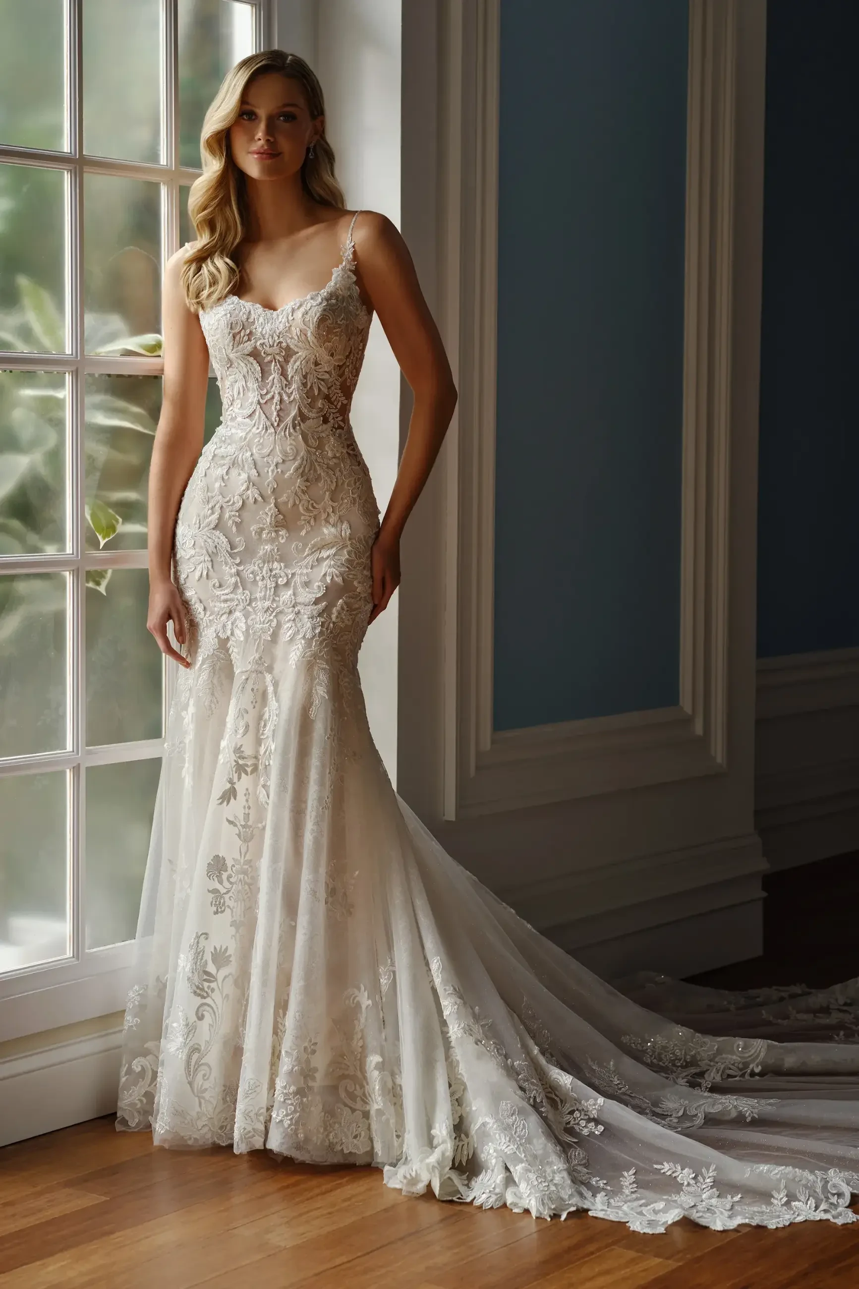 model is wearing a sleeveless fit and flare lace bridal gown