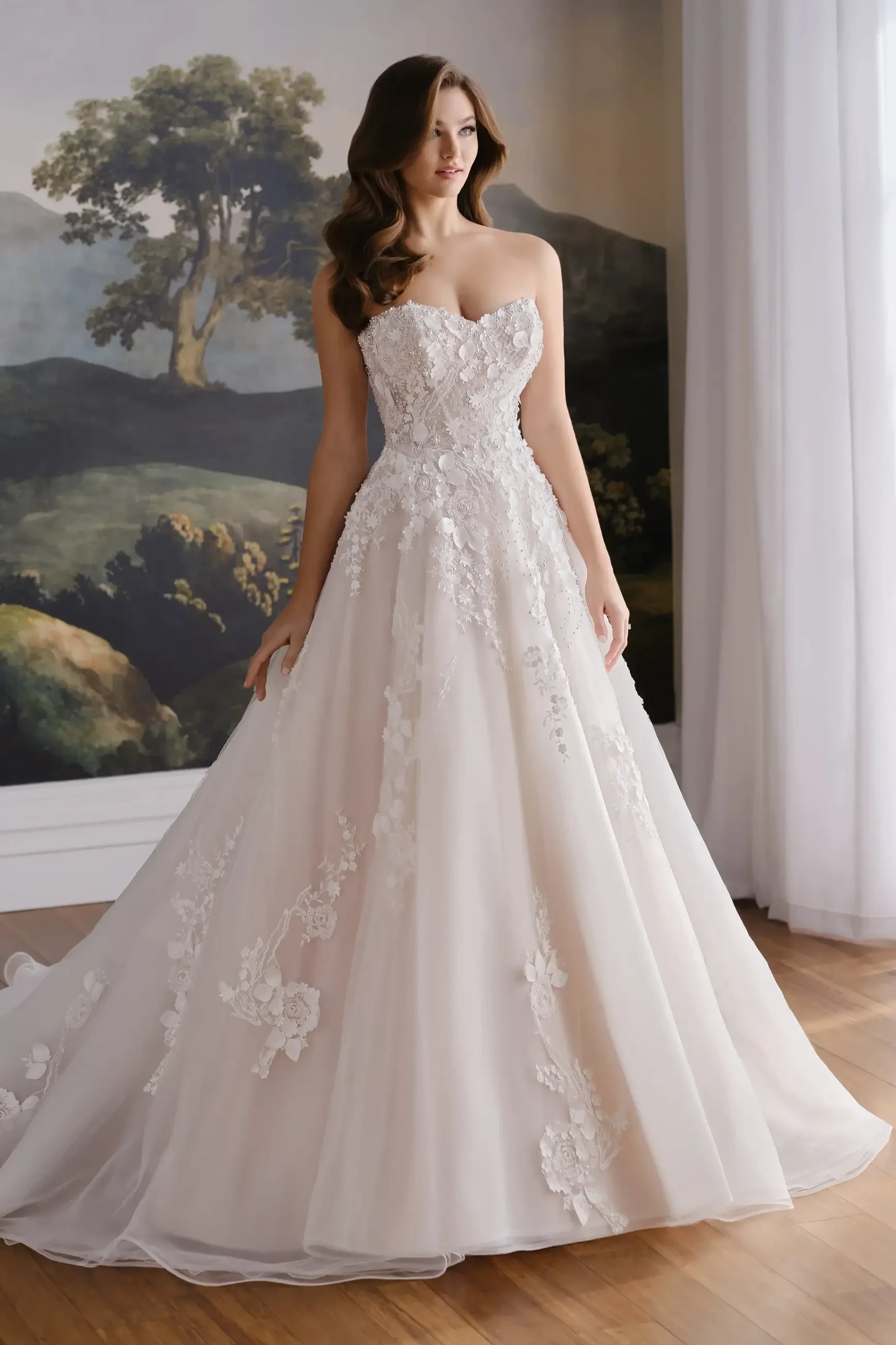Model is wearing the Romilly ball gown (MT8105), crafted from airy organza with a strapless sweetheart neckline and removable pearl beaded straps.
