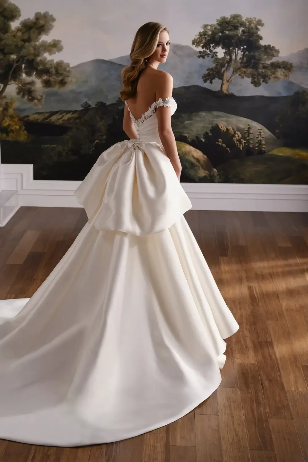 model is wearing a mikado fit and flare bridal gown