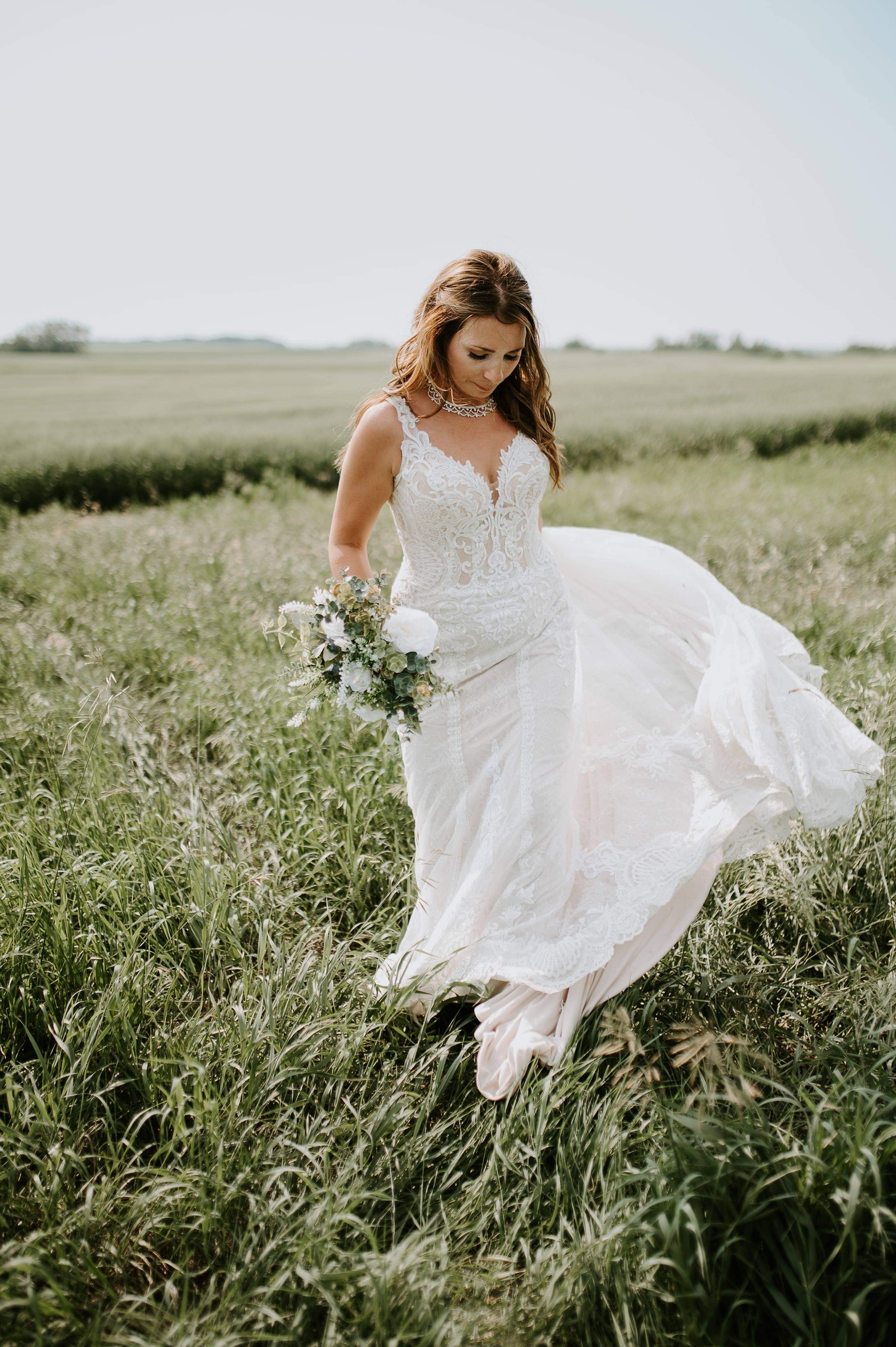 bride walking through field