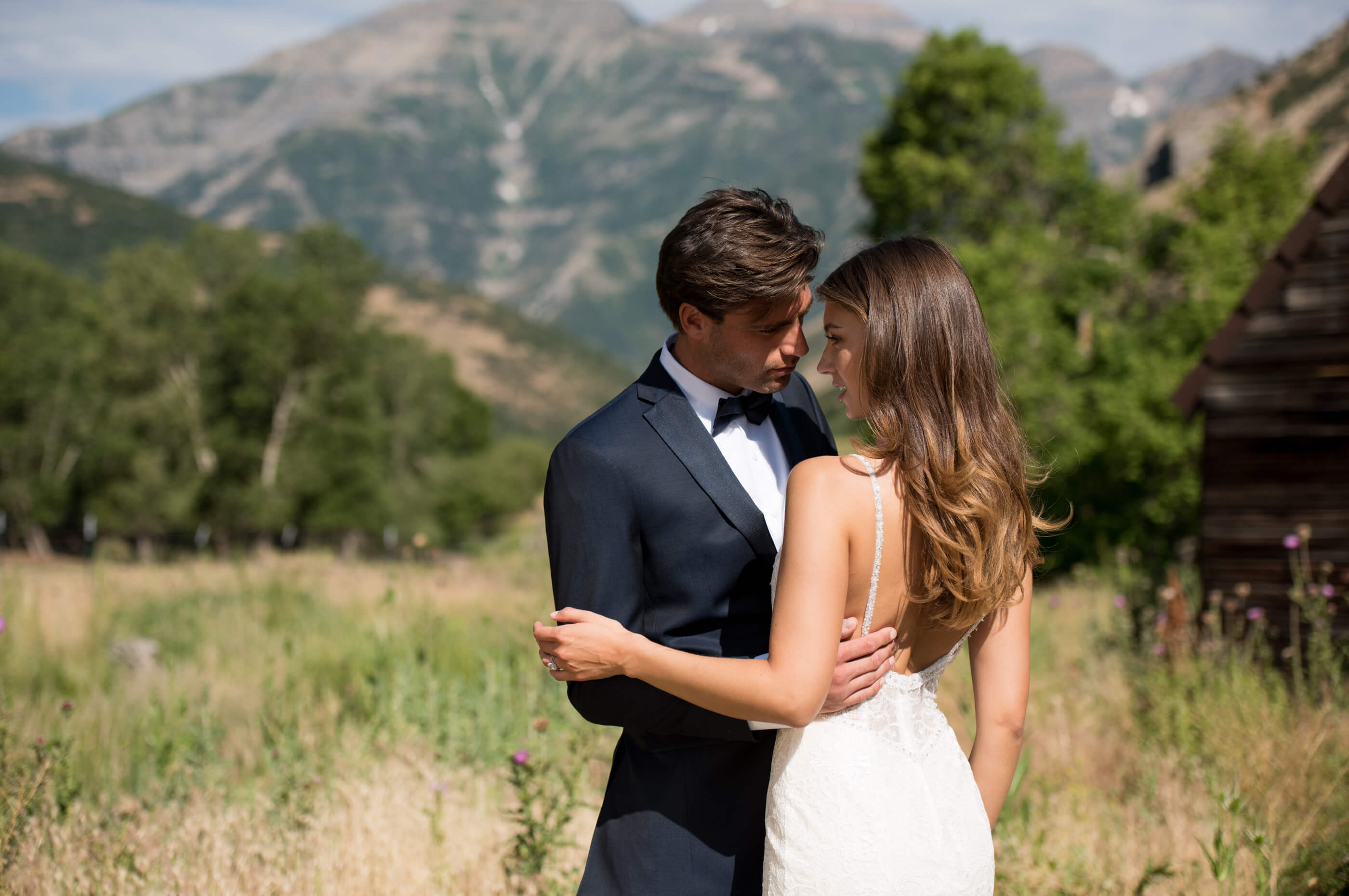 Brunette bride and groom in field