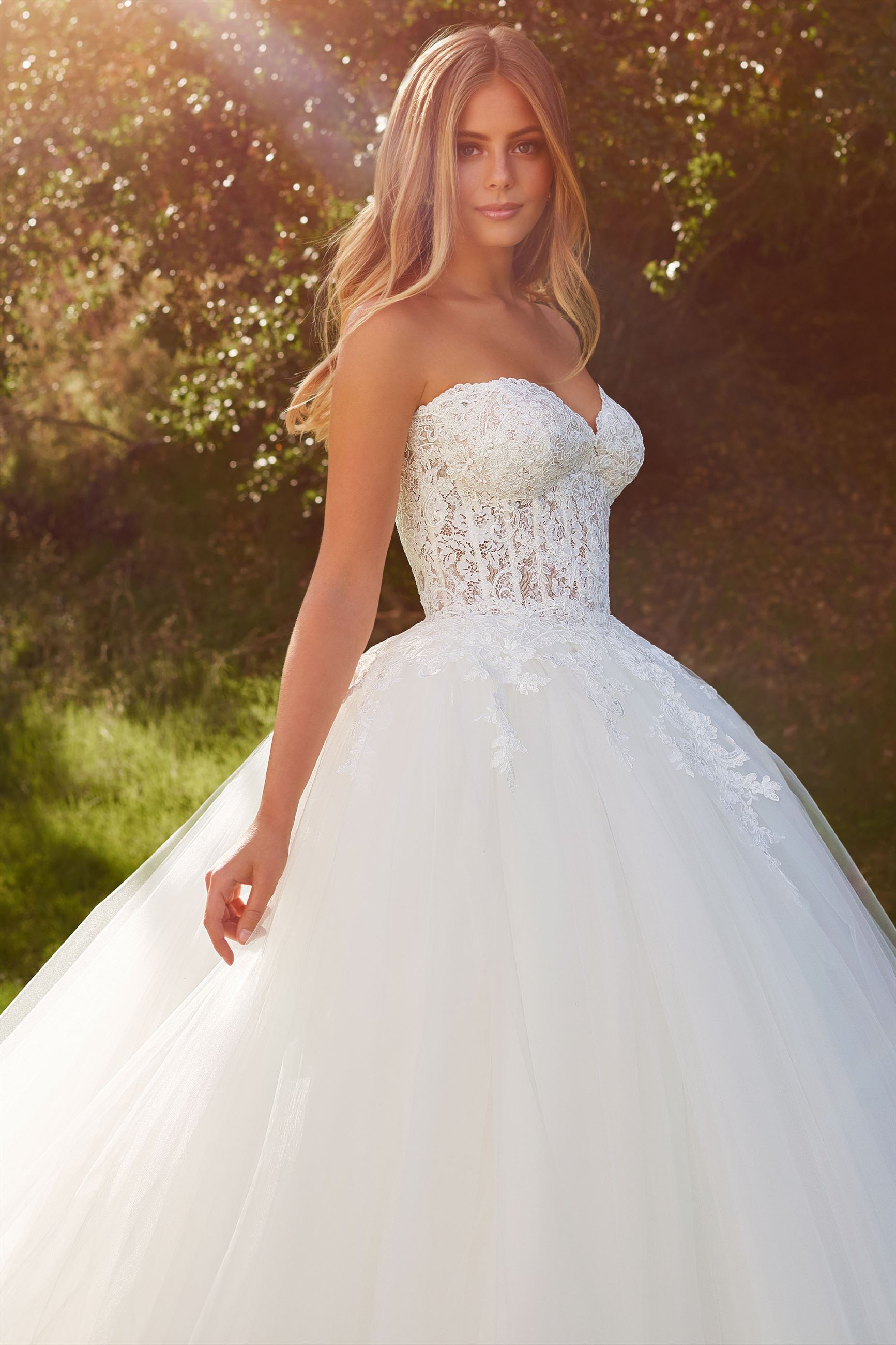 Blonde bride wearing strapless ball gown wedding dress