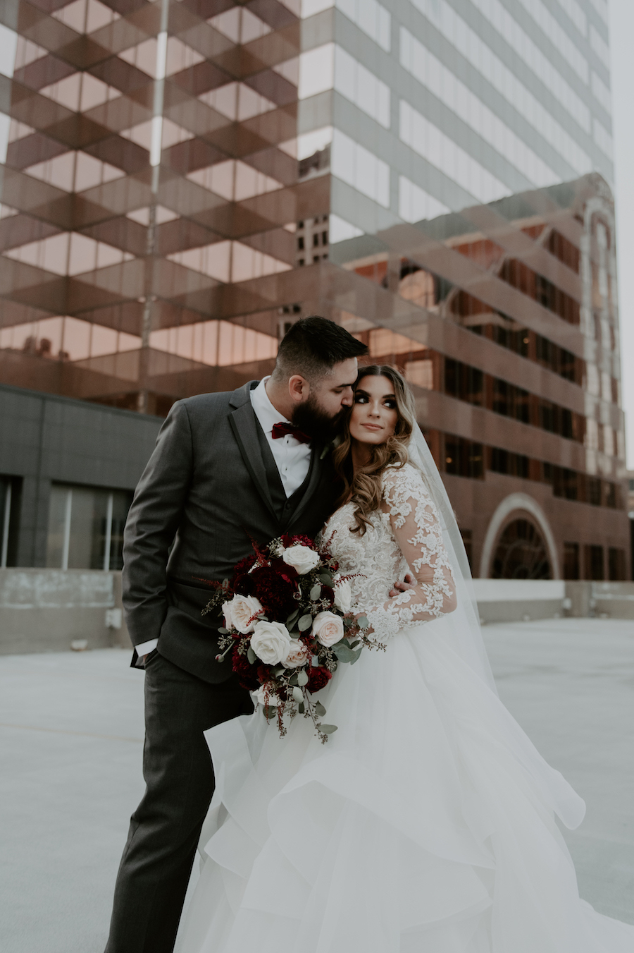 groom kissing bride on cheek