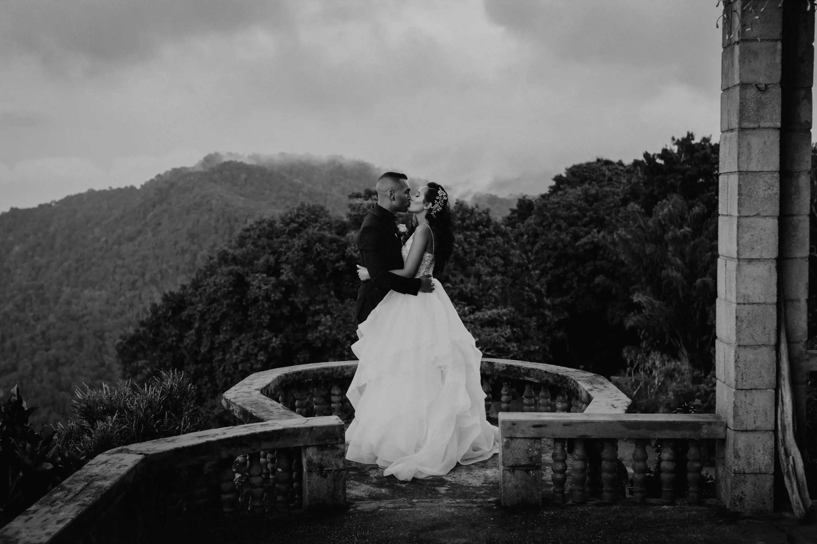 Сouple wearing a white gown and a black suit. Black and white photo