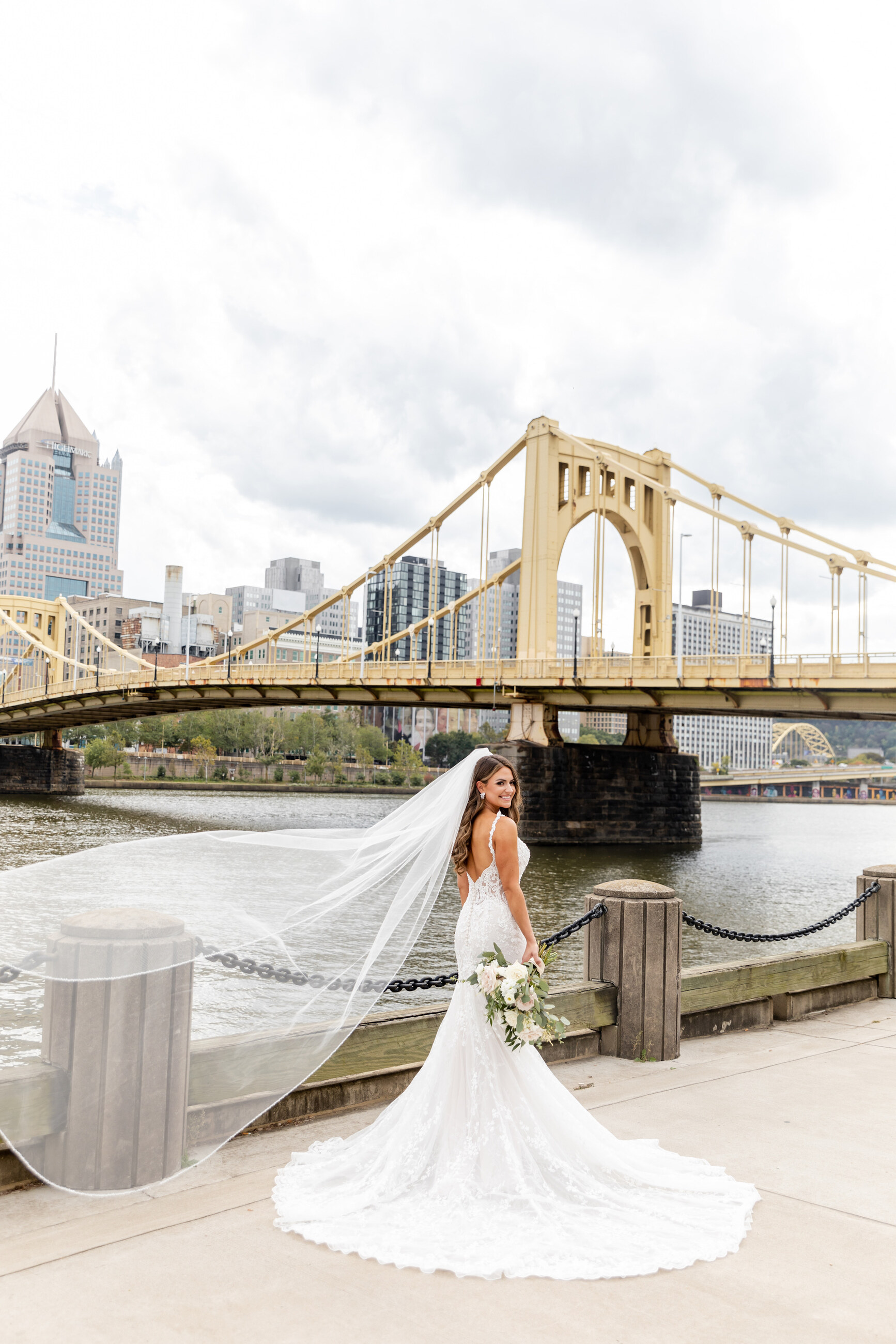 bride wearing veil in from of the city