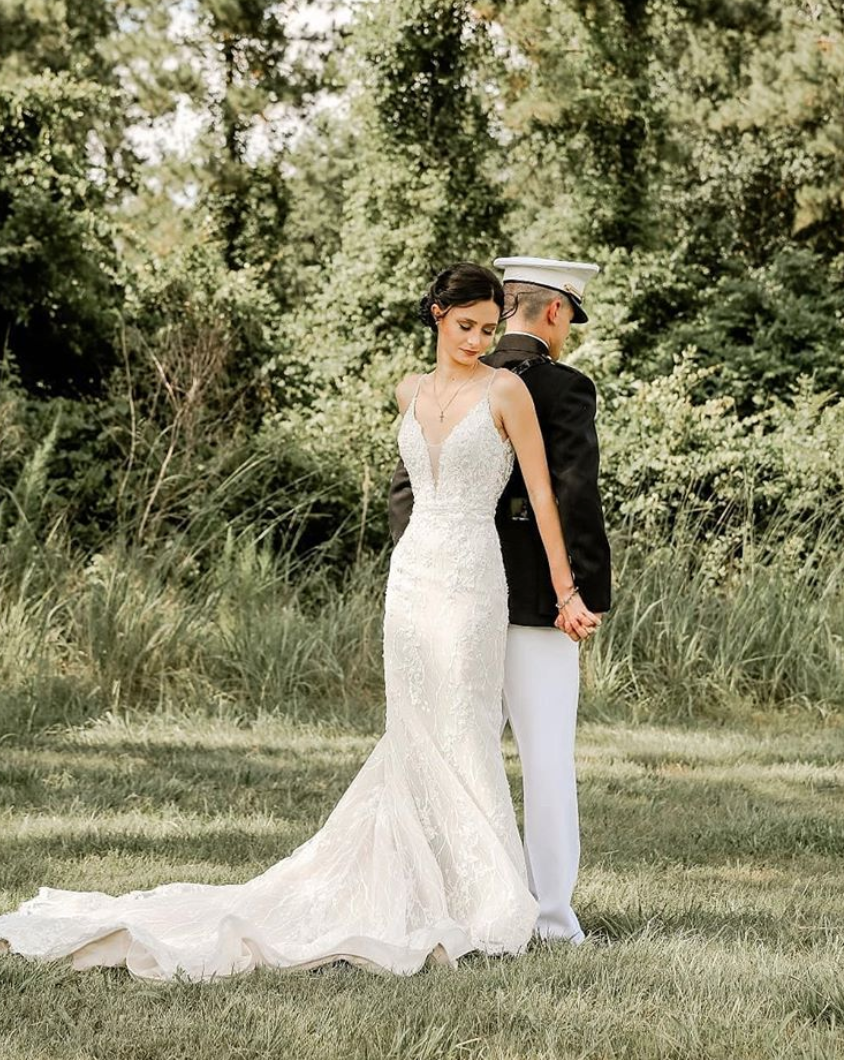 Bride and groom standing back to back