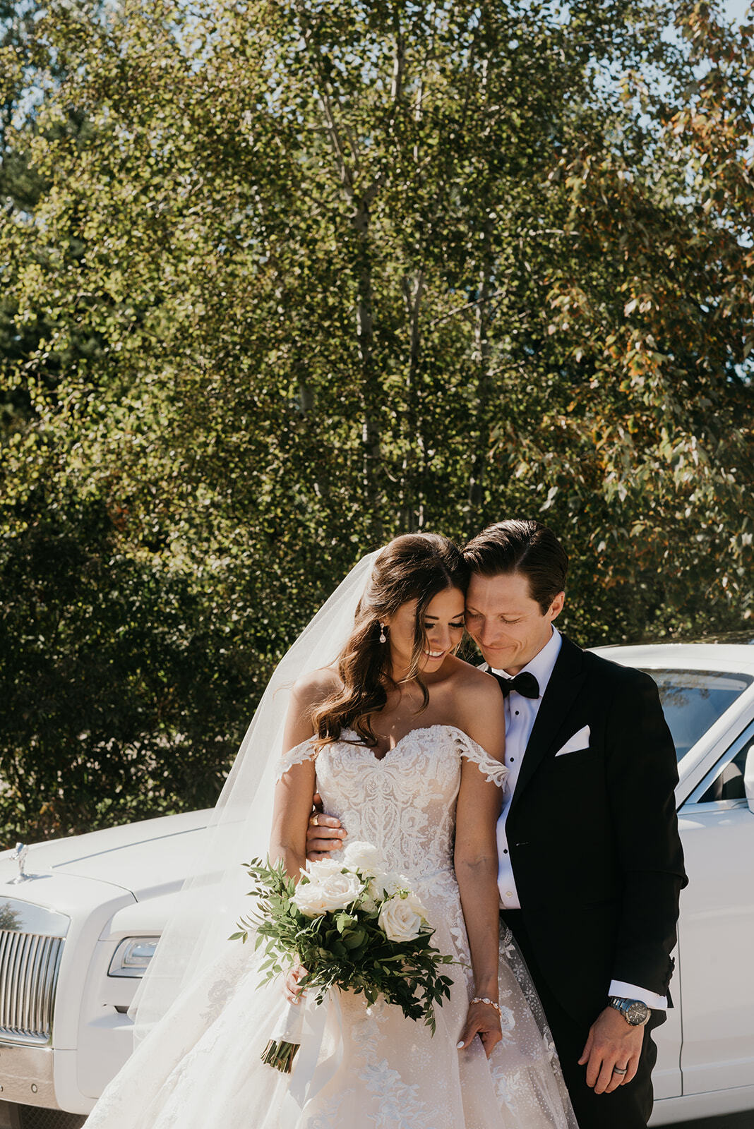 bride and groom in front of a vintage car