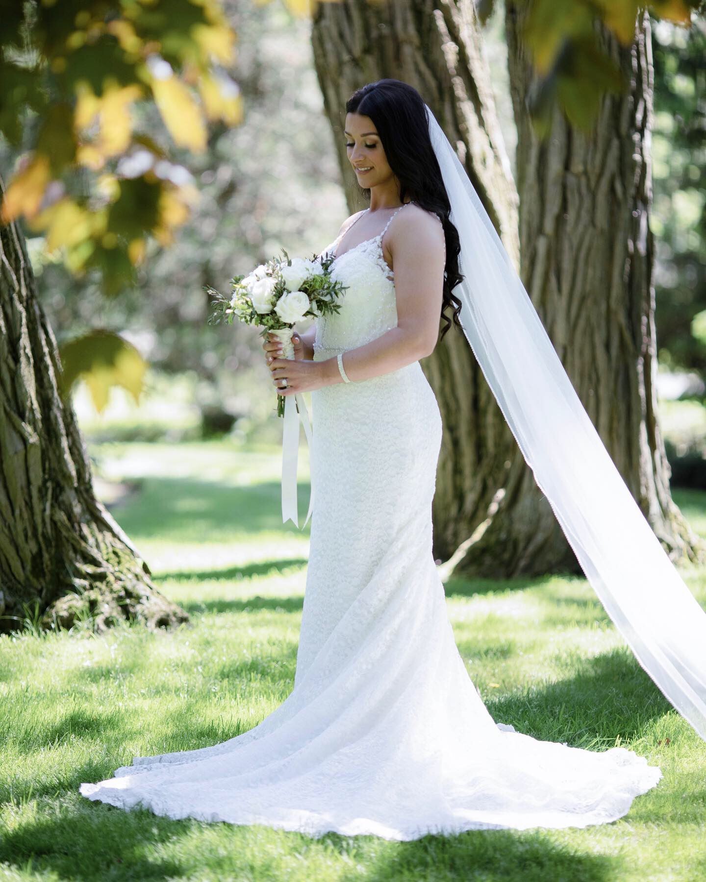 Real bride on her wedding day holding a floral bouquet