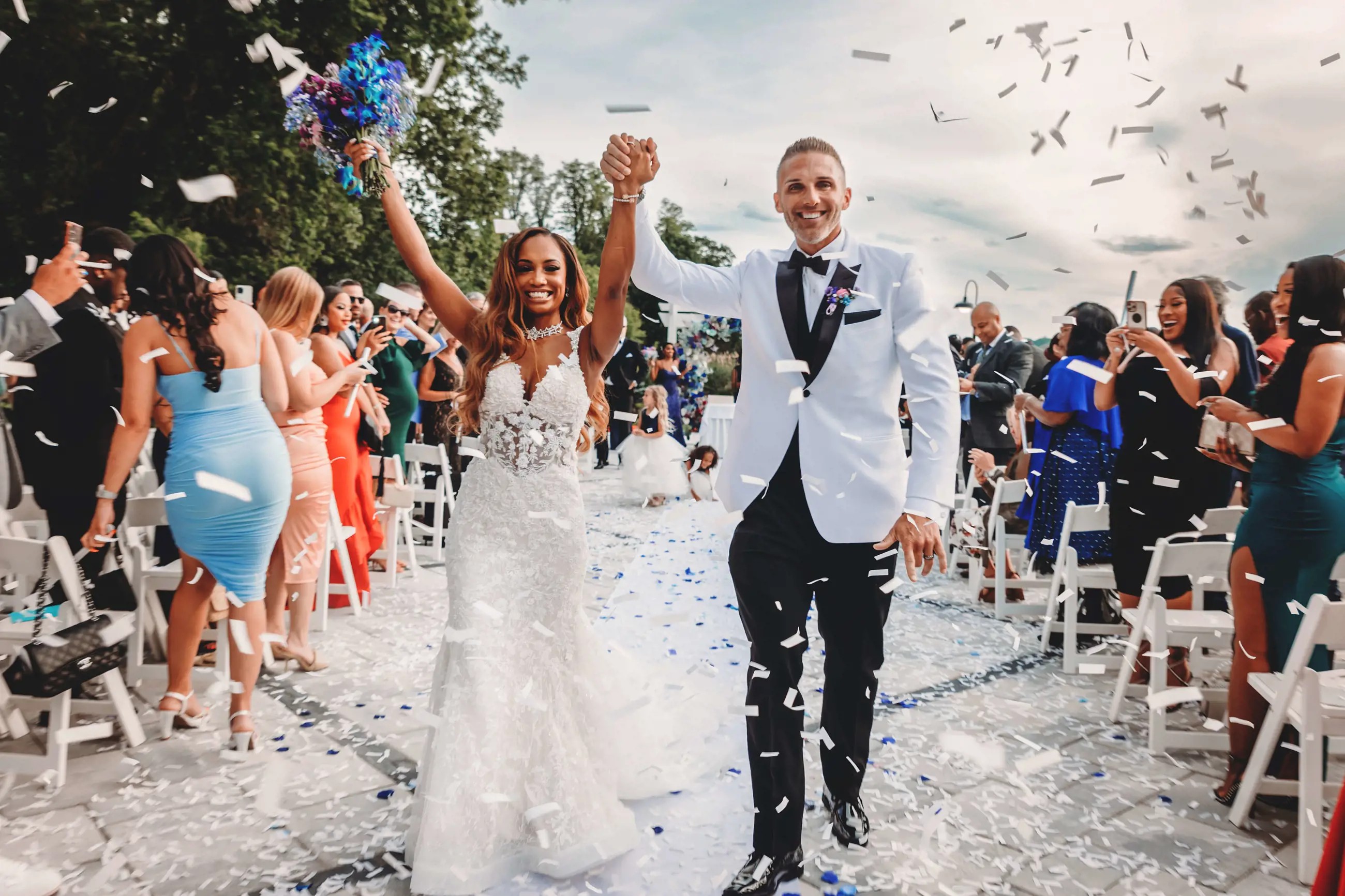 Сouple wearing a white gown and a white suit