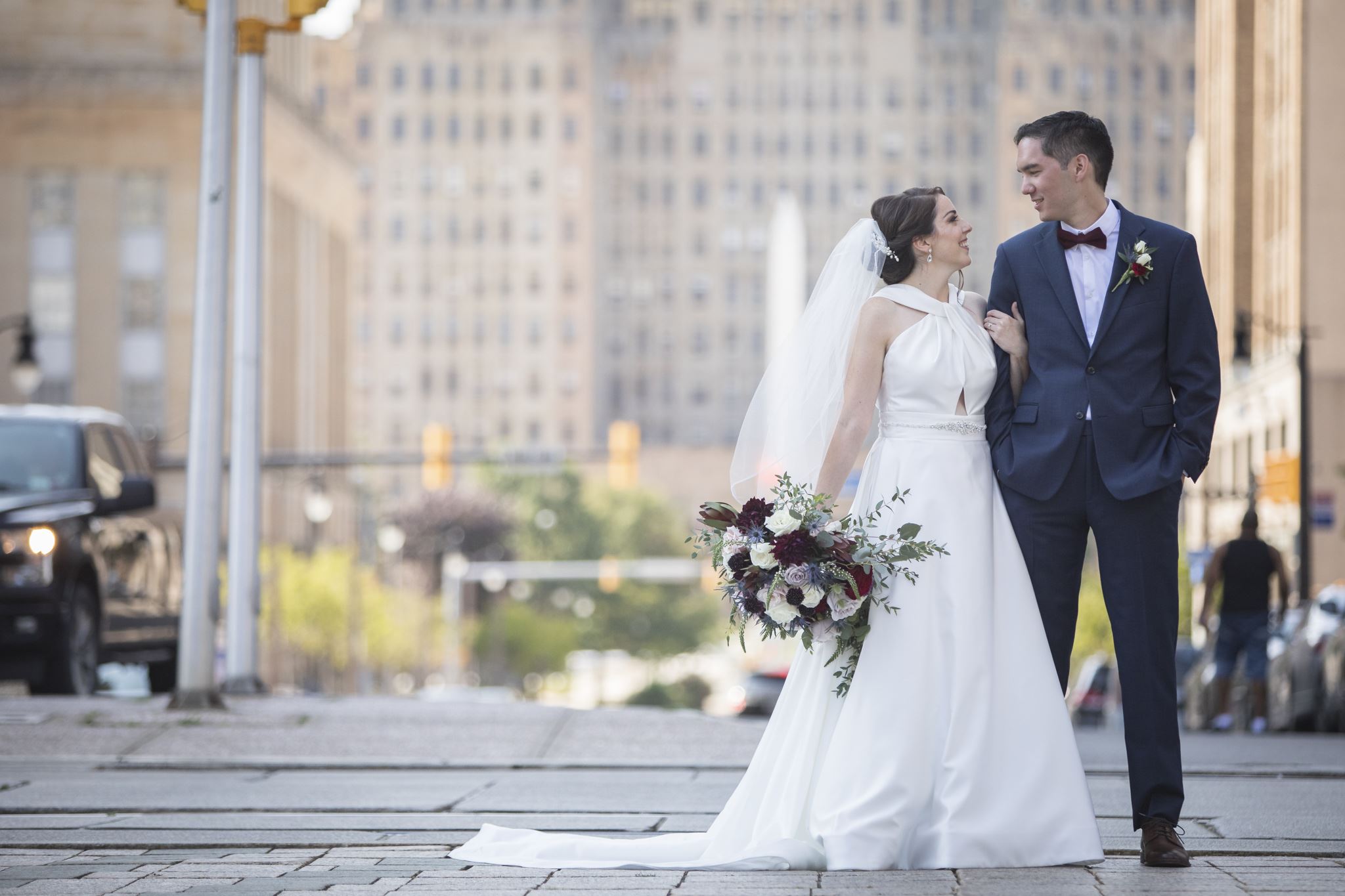 Bride and groom standing together in the city on their wedding day